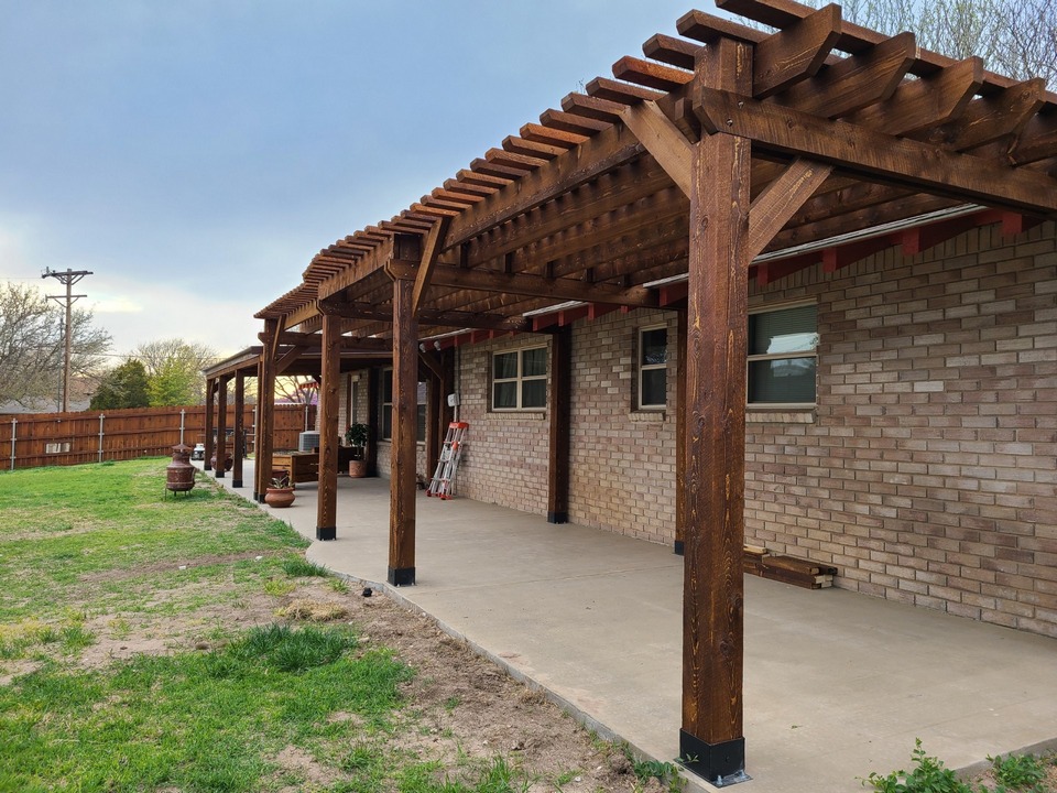 pergola installed over backyard patio